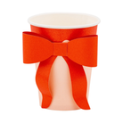 Red and pink paper party cup with a large red paper bow attached to the front, perfect for festive holiday gatherings.