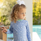 Girls’ long sleeve rashguard one piece swimsuit in Seaside Seersucker with UPF 50+ and scalloped open back, perfect for summer or beach vacations by Henry Duvall.