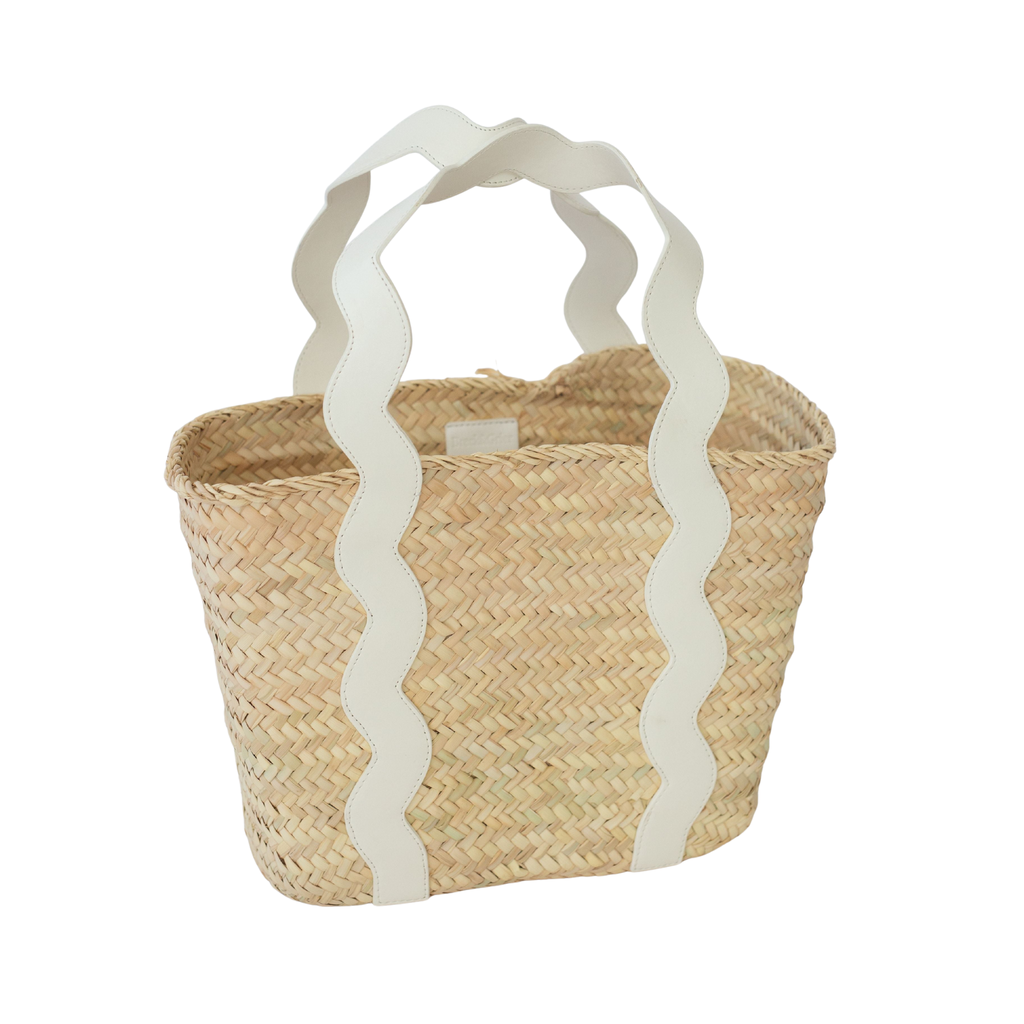 Henry Duvall curated Ridgely Tote by Breck & Grier, a classic straw tote bag with woven body and vegan leather handles.