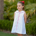 Henry Duvall Lucy Dress in blue micro dot cotton featuring a Peter Pan collar, red scalloped trim, and embroidered crayons, classic girls back-to-school dress for first day of school photos and classroom celebrations.