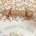 Turkey-shaped Thanksgiving party crackers with tissue crowns, dice, and mini games – festive table decorations for holiday gatherings