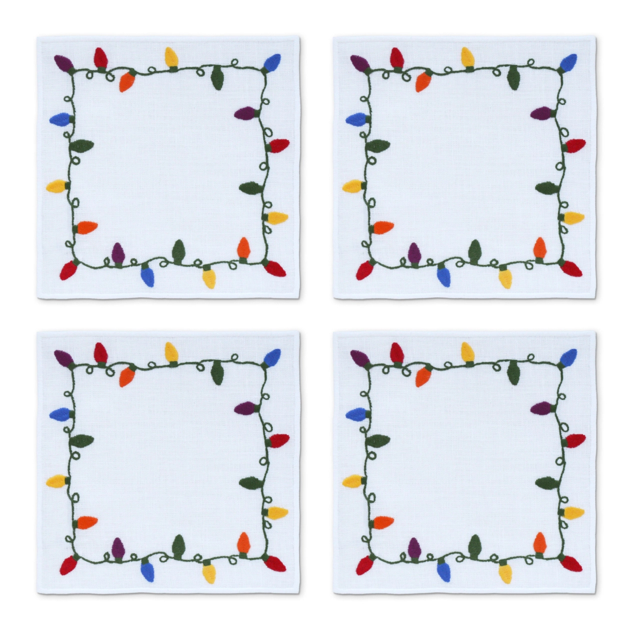 Set of four white linen cocktail napkins with embroidered multicolor Christmas lights framing each edge
