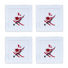 Four white cotton cocktail napkins featuring a red and black embroidered skiing Santa design.
