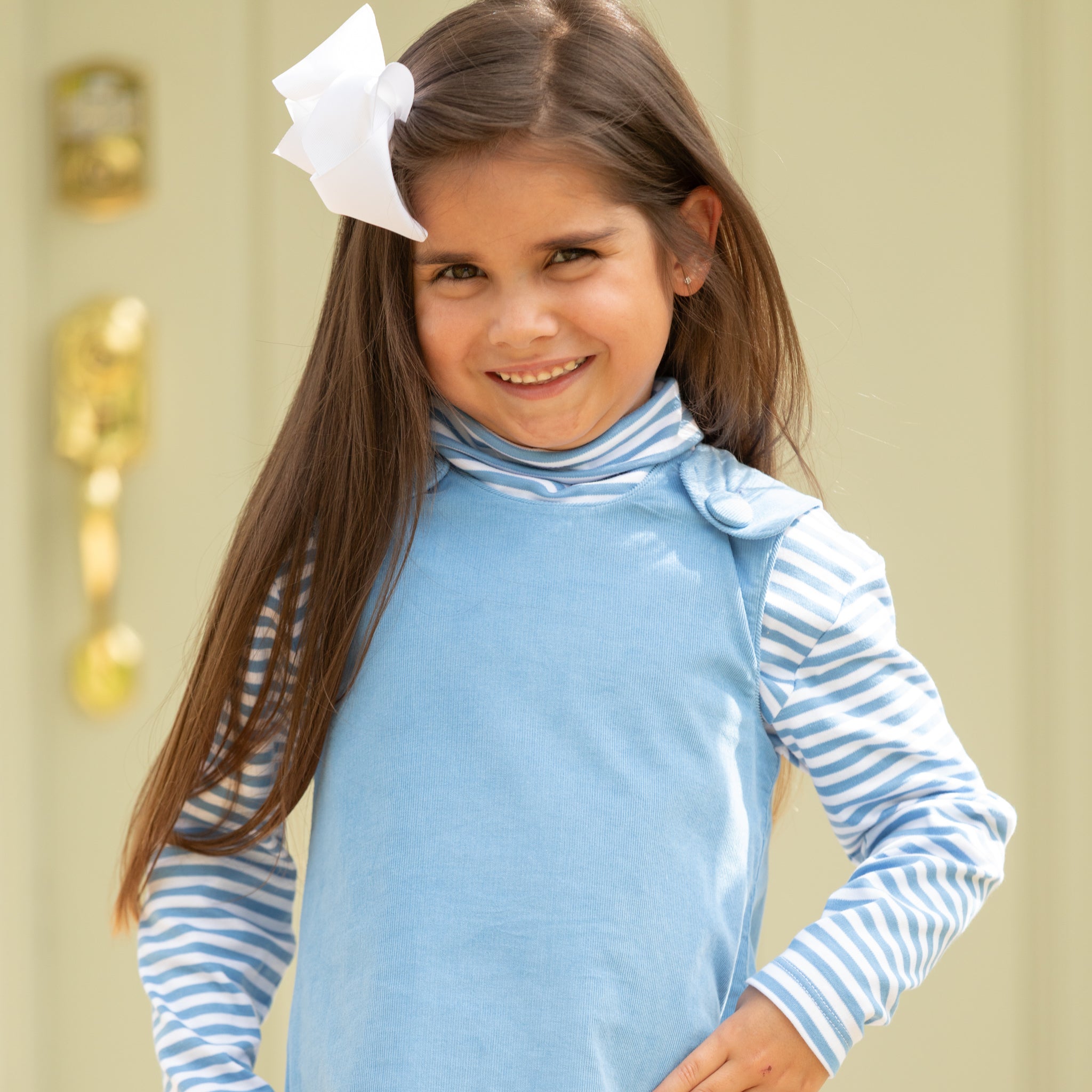 Henry Duvall Janie Jumper girls’ dress in Brookhaven Blue corduroy with scalloped hem and fabric-covered shoulder buttons, designed for layering with blouses and turtlenecks for fall.