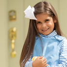 Henry Duvall Janie Jumper girls’ dress in Brookhaven Blue corduroy with scalloped hem and fabric-covered shoulder buttons, designed for layering with blouses and turtlenecks for fall.