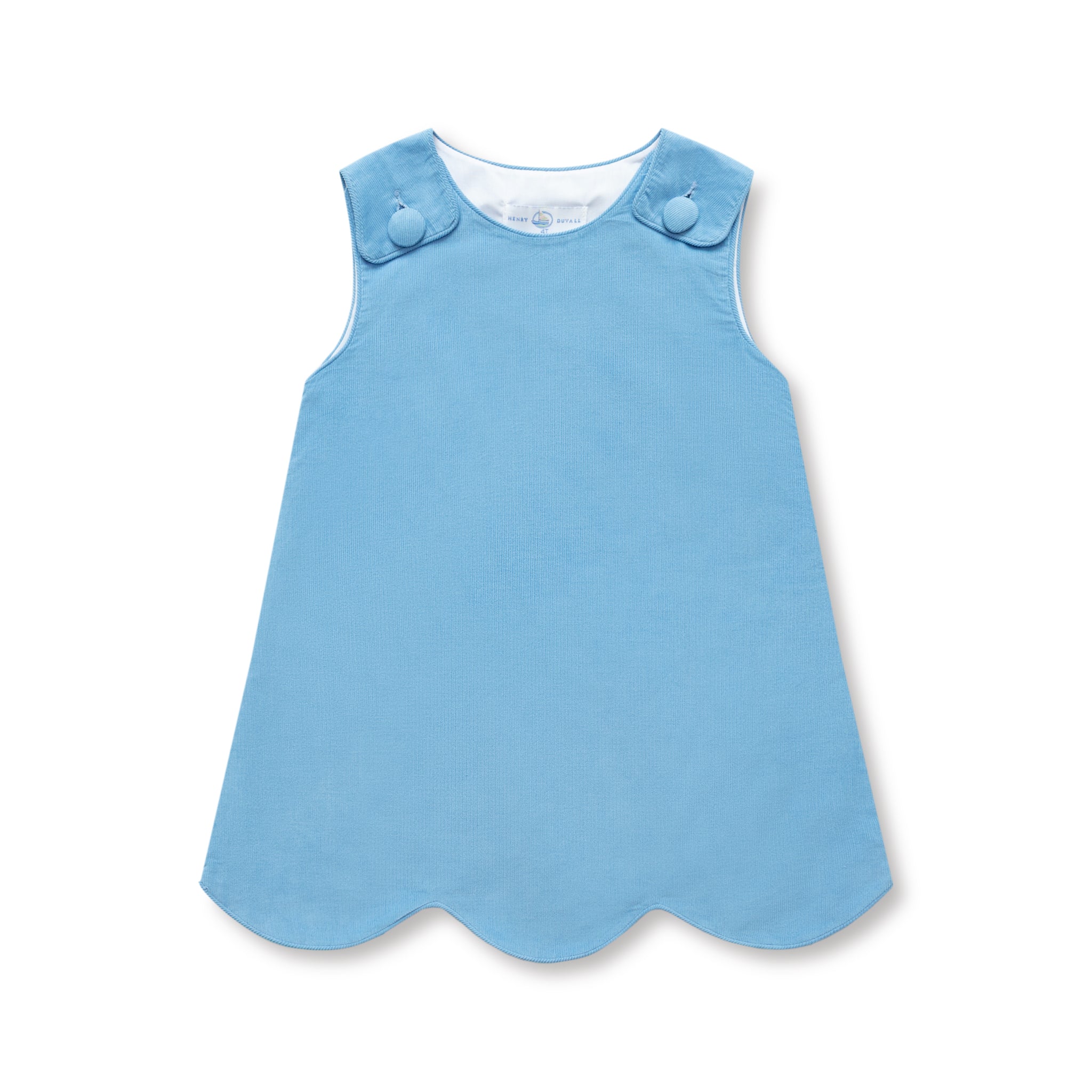 Henry Duvall Janie Jumper girls’ dress in Brookhaven Blue corduroy with scalloped hem and fabric-covered shoulder buttons, designed for layering with blouses and turtlenecks for fall.