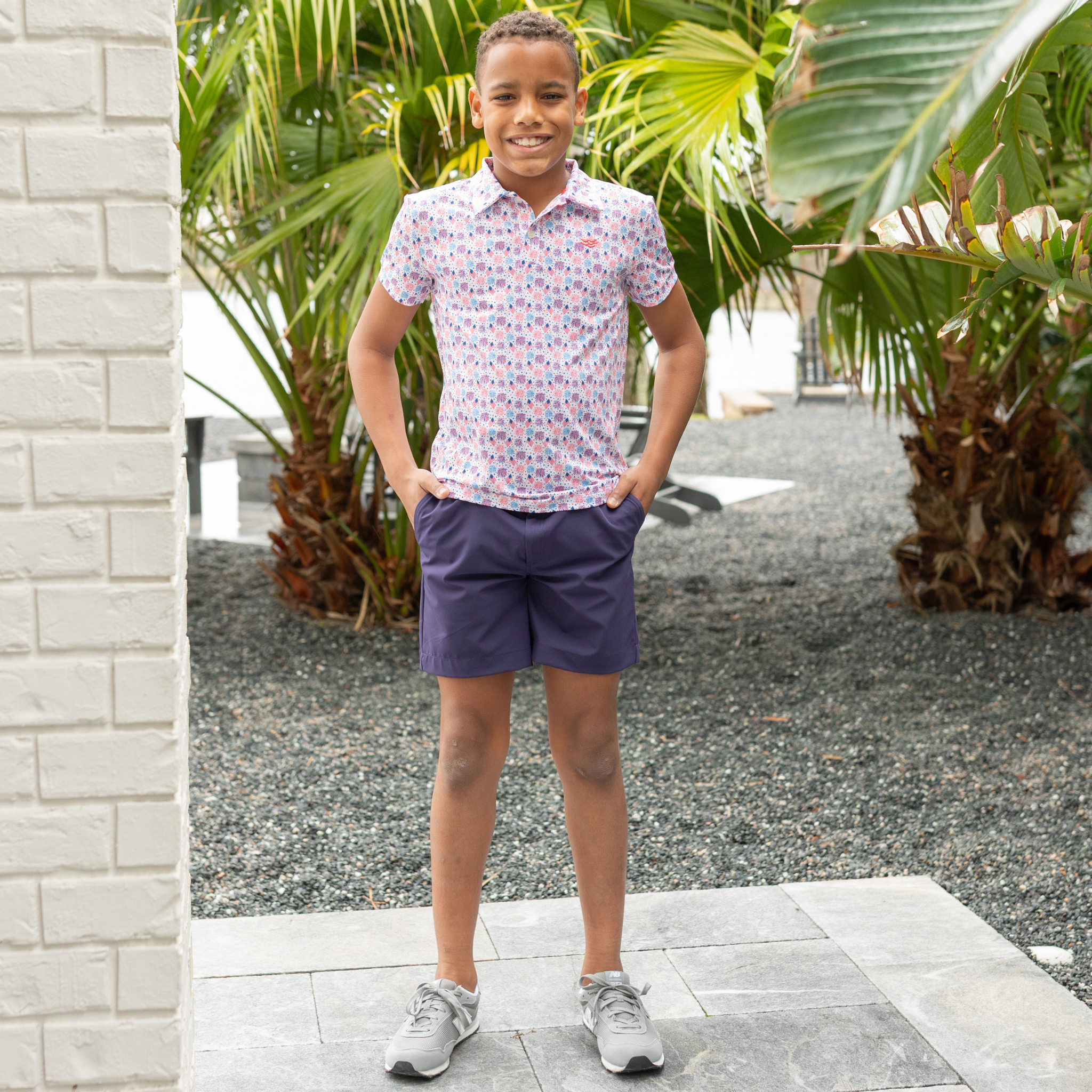 Henry Duvall boys patriotic performance polo with red white and blue fireworks and flag print, preppy UPF summer shirt for Memorial Day, 4th of July, and everyday wear