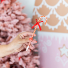 Red and pink candy cane-shaped holiday pens with festive bows, perfect for kids’ stockings or holiday gift bags; fun and colorful with peppermint-scented ink