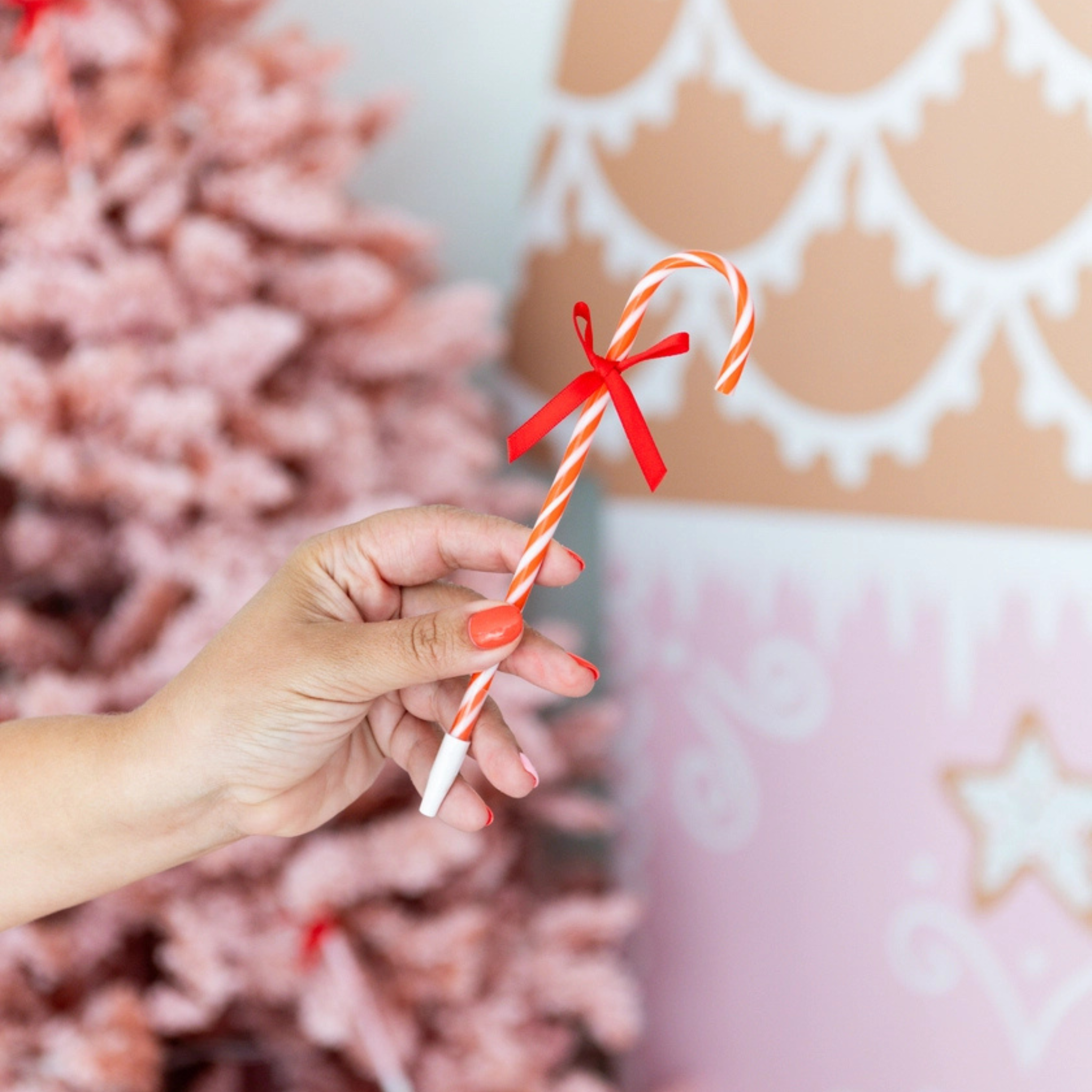 Red and pink candy cane-shaped holiday pens with festive bows, perfect for kids’ stockings or holiday gift bags; fun and colorful with peppermint-scented ink