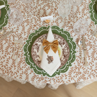 Classic round green scalloped placemats with white embroidery, perfect for Thanksgiving or holiday table settings, handcrafted from a premium cotton blend.