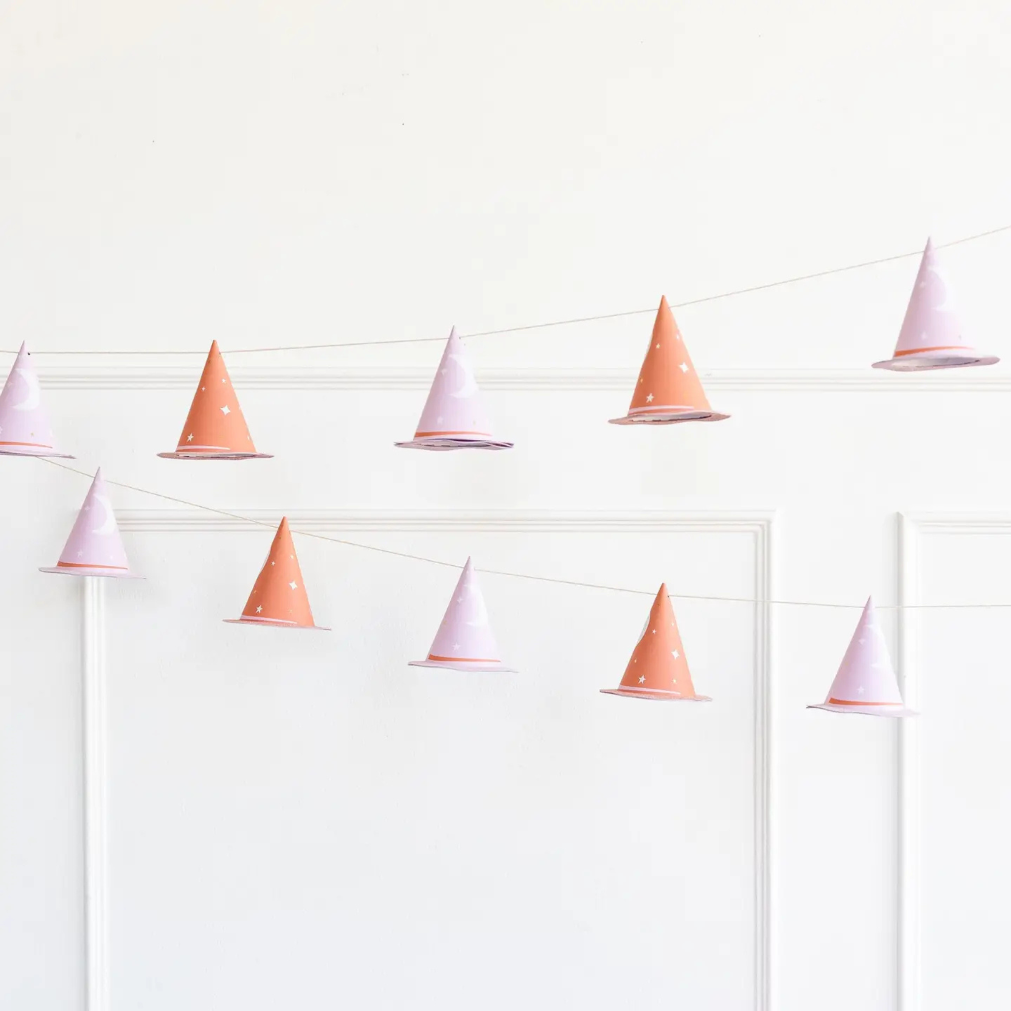 Pink Witch Hat Banner with gold foil stars and glittered brims, six-foot Halloween garland with 12 mini hats, perfect for whimsical holiday party decor