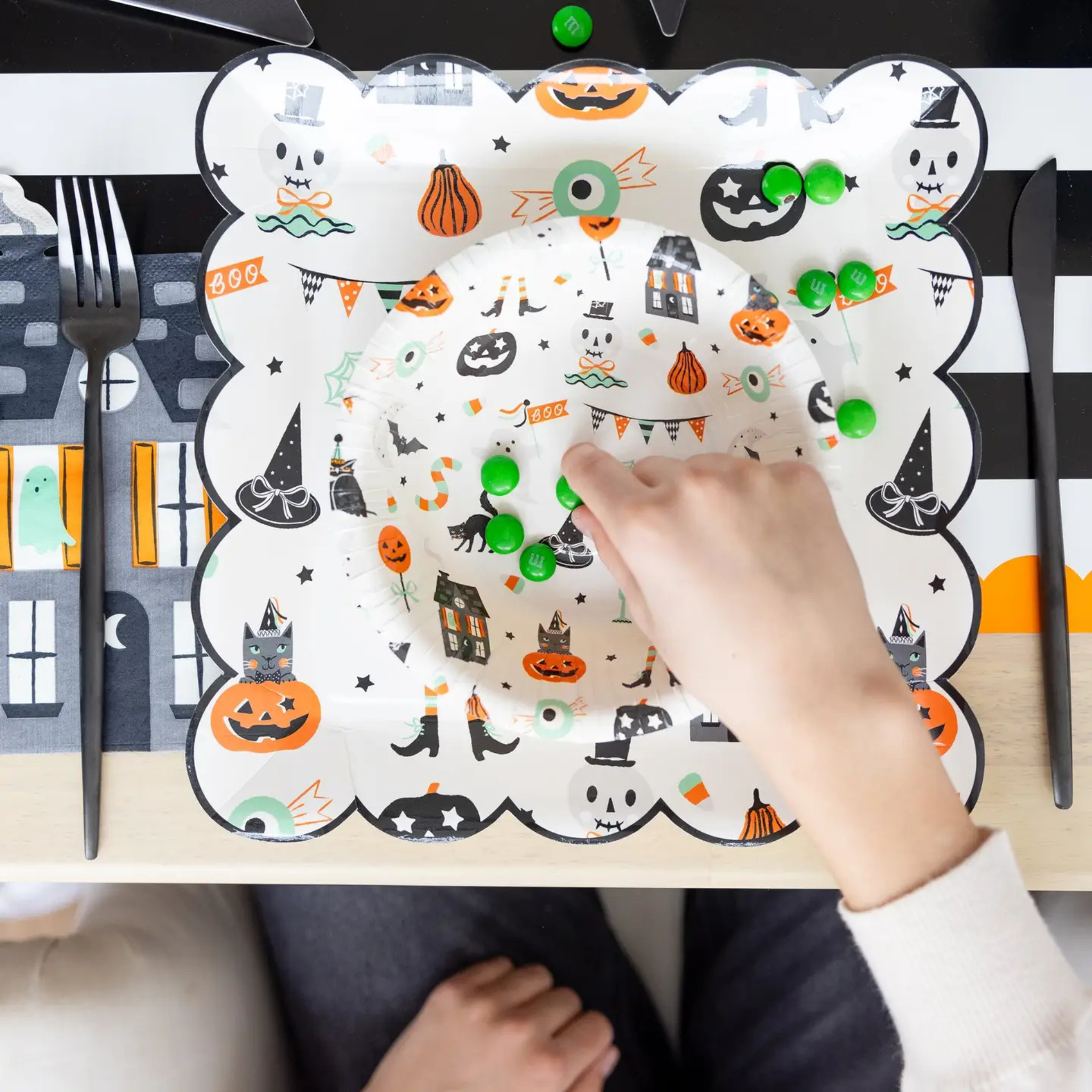 Tricks & Treats Halloween Plates, set of 8 round 10-inch paper plates in orange and black with festive Halloween icon illustrations