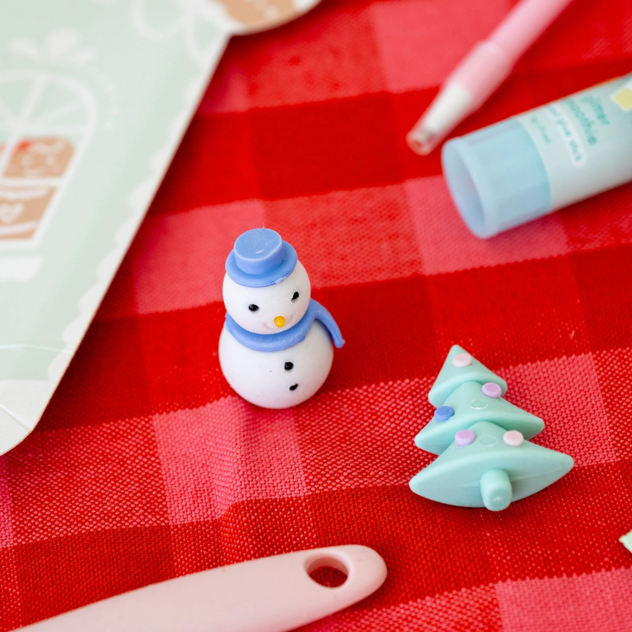 Set of eight holiday-themed vanilla-scented erasers including snowman, Christmas tree, Santa hat, wreath, and more; perfect for stocking stuffers and kids’ holiday gifts