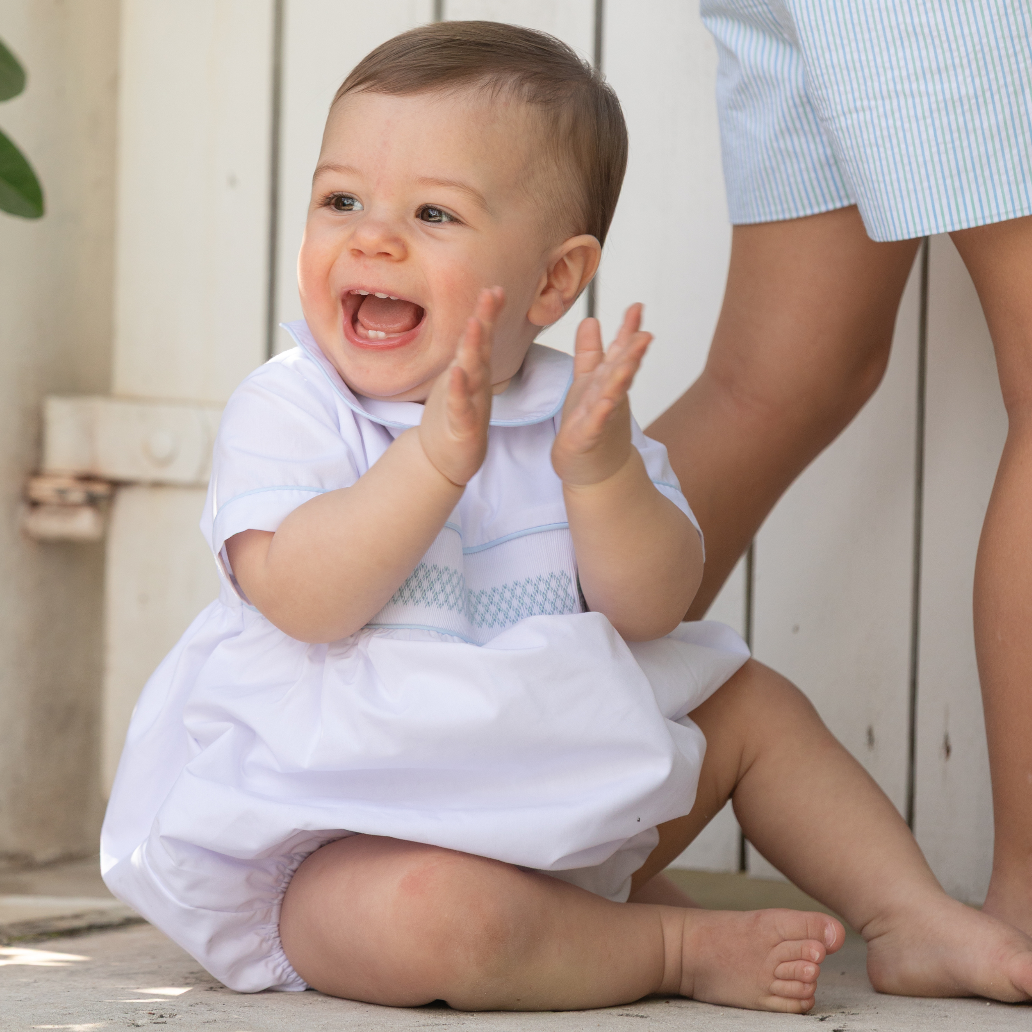 Henry Duvall Charlie Bubble for boys in white cotton with Bailey’s Bay Blue trim and smocked sailboat, classic summer baby boy outfit with Peter Pan collar