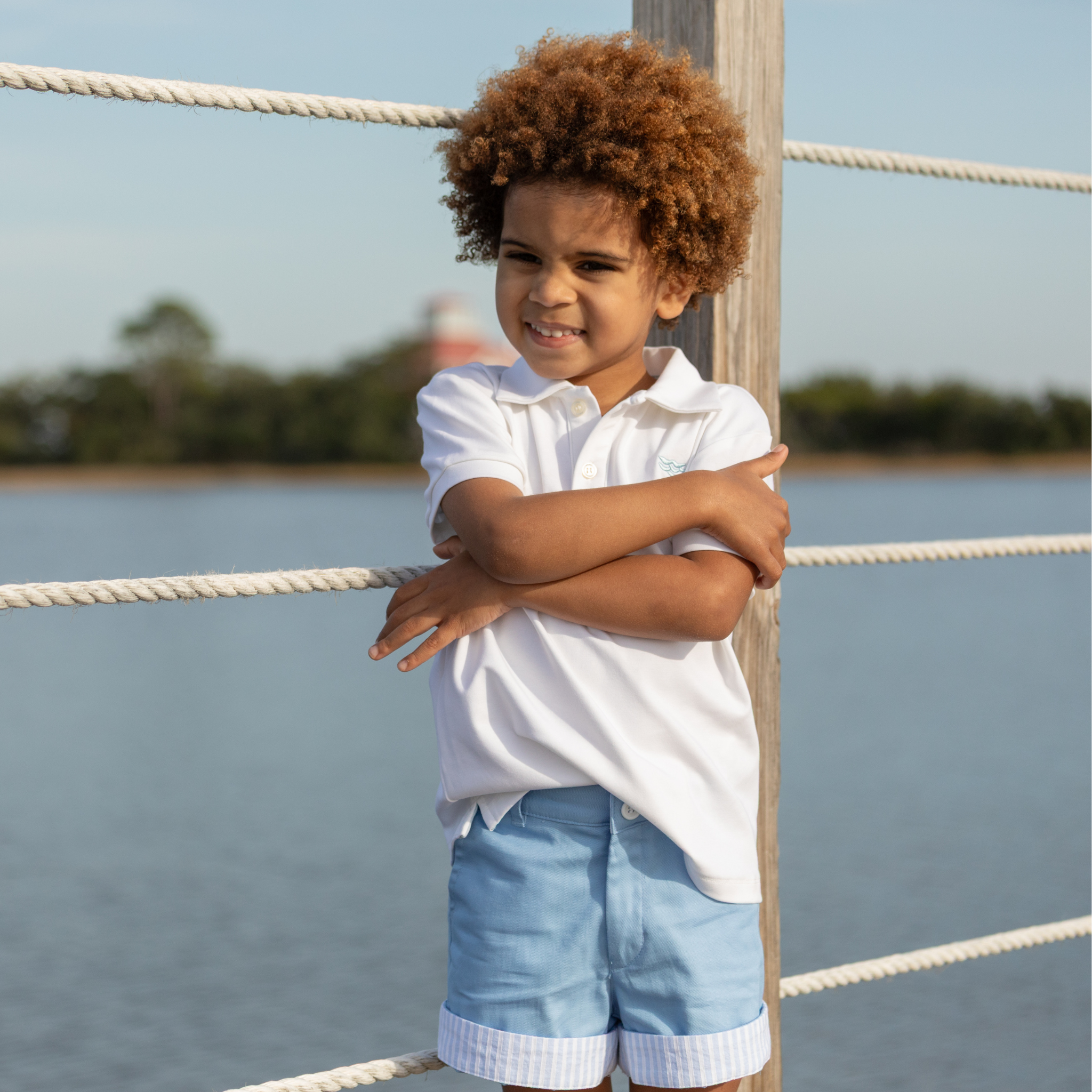 Boy wearing Henry Duvall Wyatt Shorts in East Beach Blue with striped cuffs, a classic boys short styled for spring days and timeless family moments