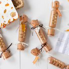 Turkey-shaped Thanksgiving party crackers with tissue crowns, dice, and mini games – festive table decorations for holiday gatherings