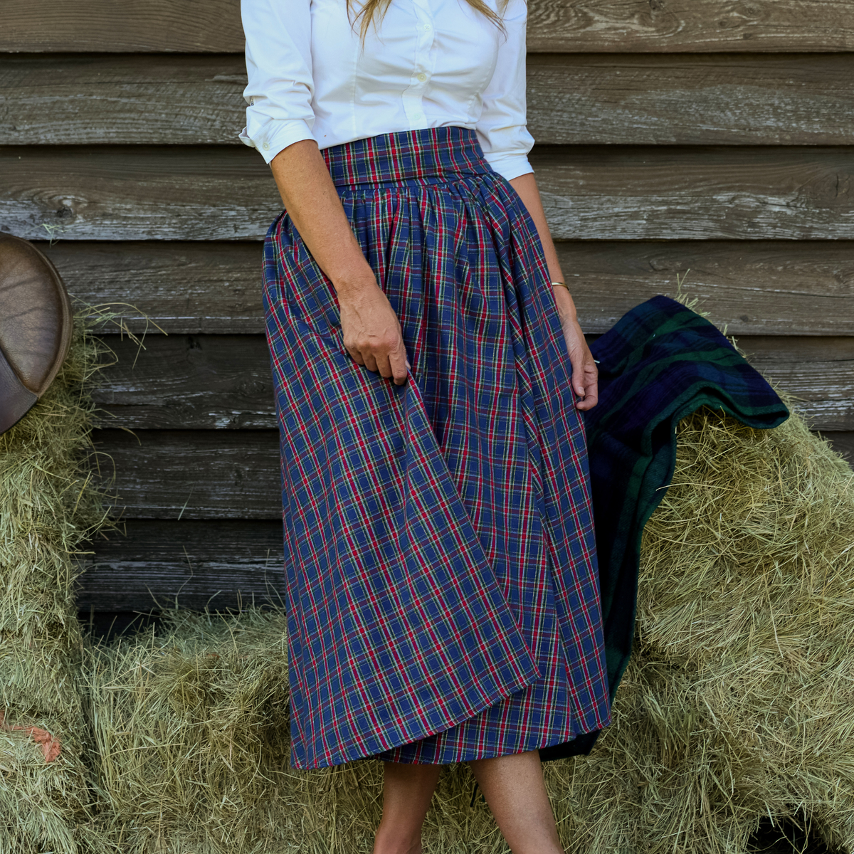 Women’s Audrey Skirt in navy, red, and green Tinsel Tartan with subtle metallic thread, featuring a full gathered midi-length silhouette.