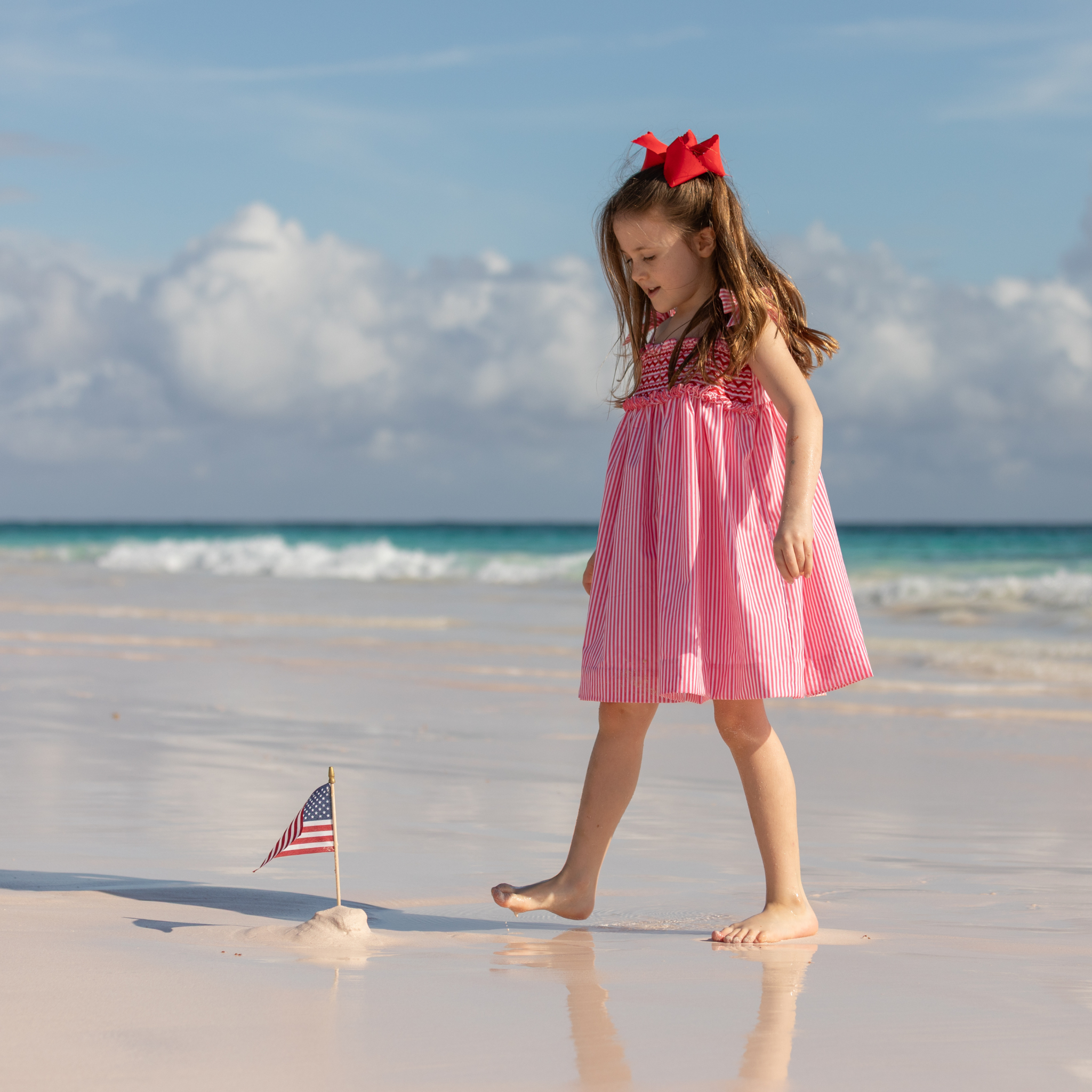 Henry Duvall Daisy Dress in red & white stripe print with hand-smocked bodice and shoulder bow ties, classic heirloom summer dress for girls