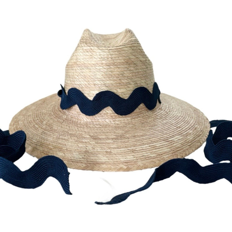 Straw hat with navy blue ribbon on a white background