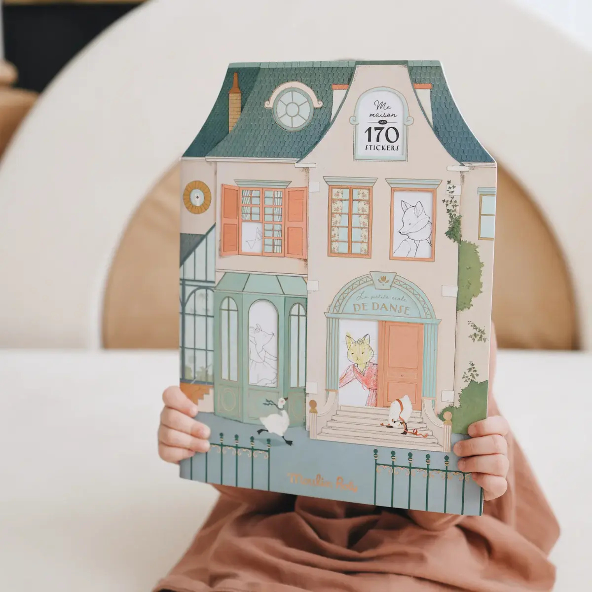 Illustrated children’s coloring and sticker book shaped like a pastel European house with ballet-themed details, perfect Christmas gift for creative kids.