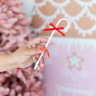 Red and pink candy cane-shaped holiday pens with festive bows, perfect for kids’ stockings or holiday gift bags; fun and colorful with peppermint-scented ink