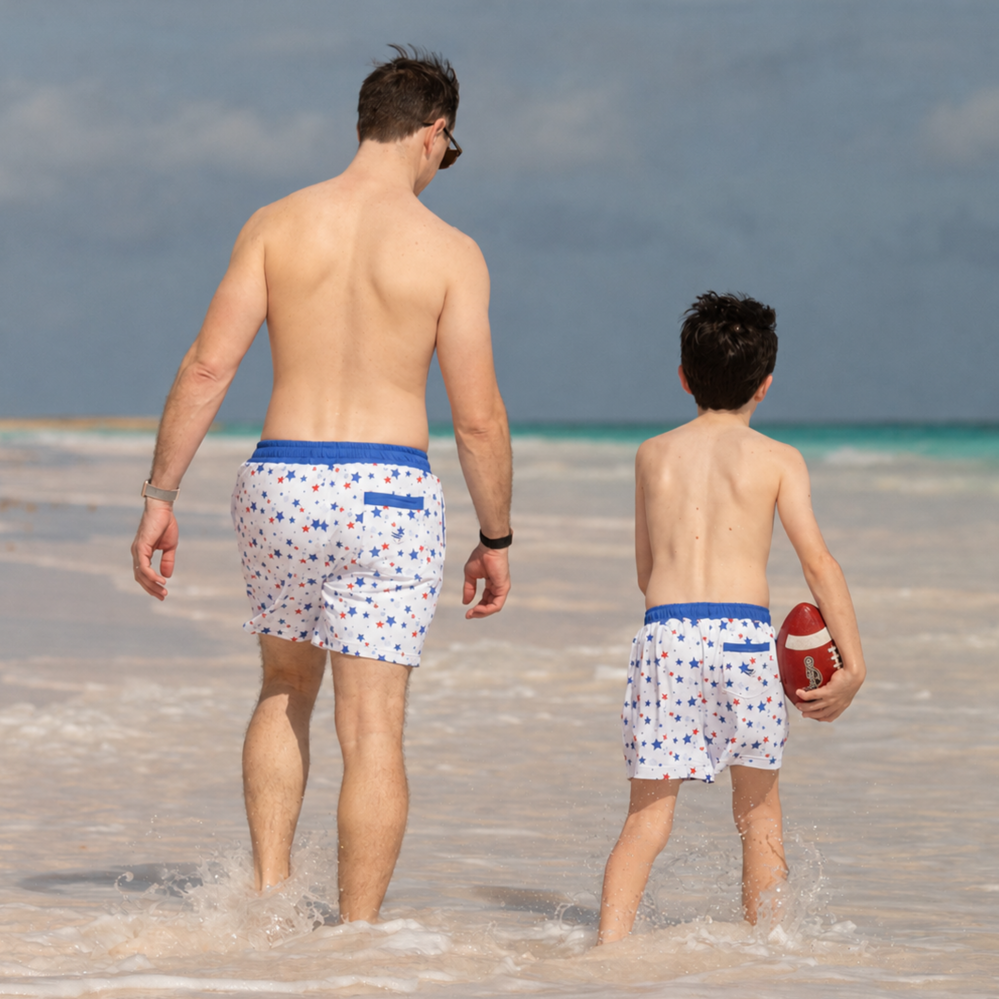 Henry Duvall Theo men’s swim trunks in Somerset Stars print with red and blue stars, UPF 50+ patriotic swim shorts for beach, vacation, and father-son matching outfits