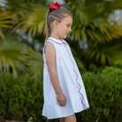Henry Duvall Lucy Dress in blue micro dot cotton featuring a Peter Pan collar, red scalloped trim, and embroidered crayons, classic girls back-to-school dress for first day of school photos and classroom celebrations.
