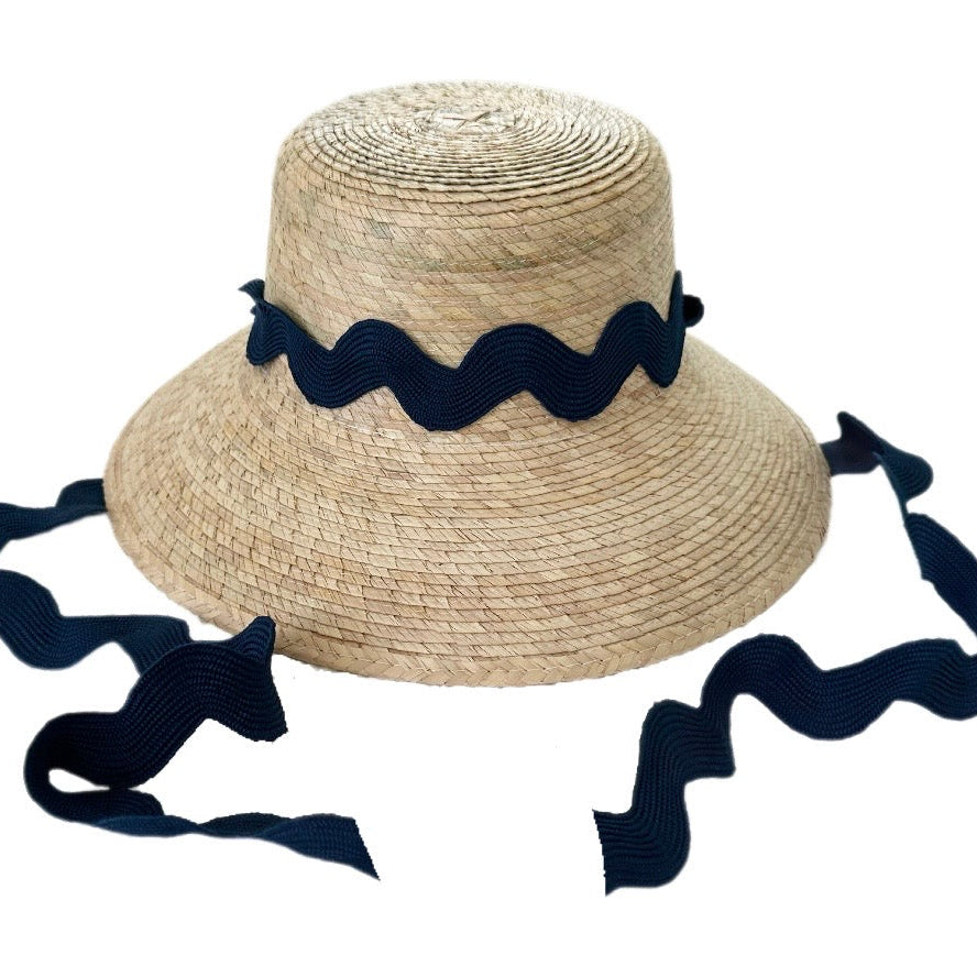 Straw hat with navy blue ribbon on a white background