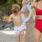 Henry Duvall baby swim shorties in red white and blue star print, patriotic UPF 50+ baby swim bloomers for Memorial Day, 4th of July, beach vacations, and summer wear