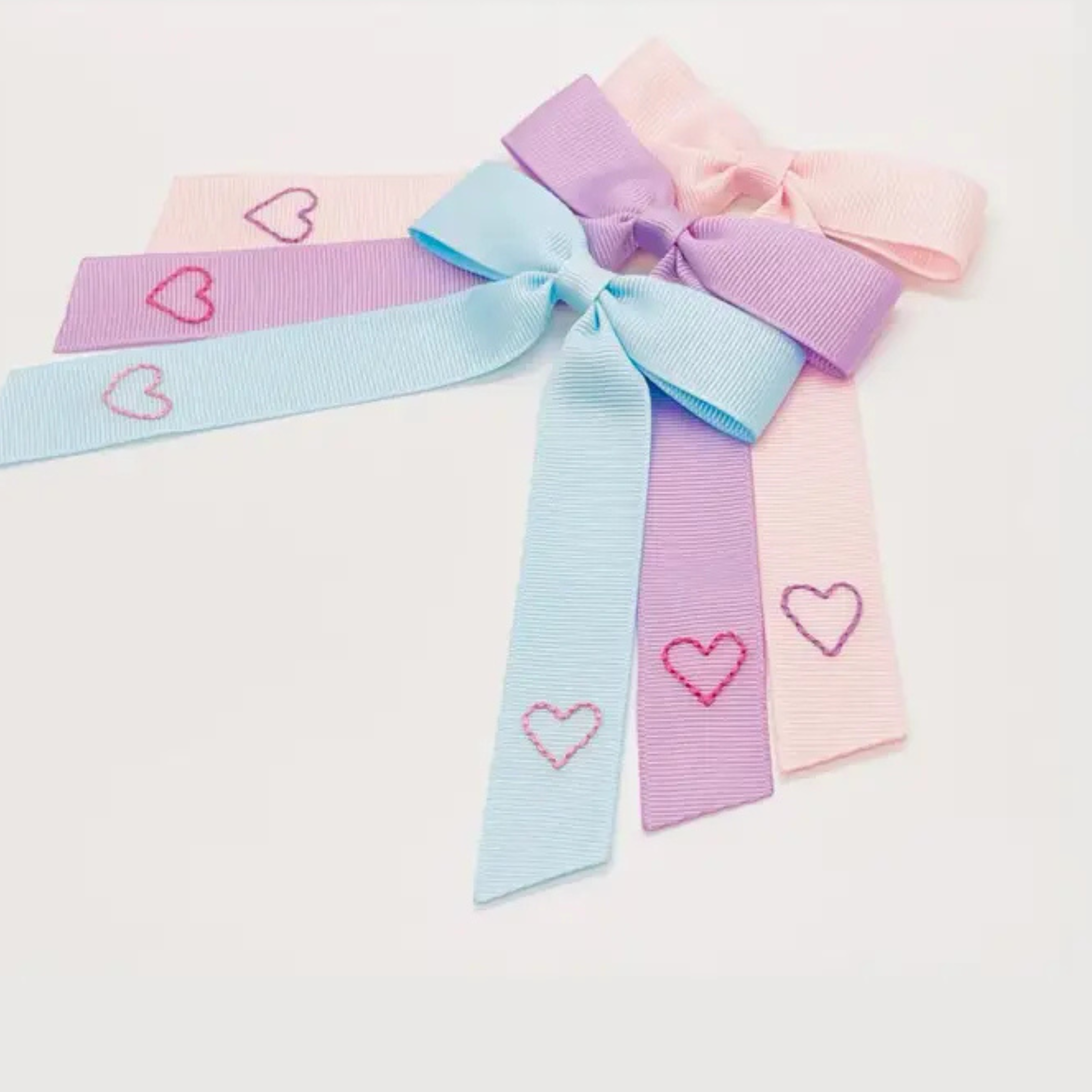 Double Hearts Bow in pale pink with embroidered hearts, small Valentine accessory.