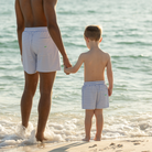 Classic boys’ swim trunks by Henry Duvall in a tailored above-the-knee fit with UPF 50+ protection, featuring an elastic waistband and drawstring for a comfortable summer look.