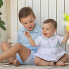 Henry Duvall Charlie Bubble for boys in white cotton with Bailey’s Bay Blue trim and smocked sailboat, classic summer baby boy outfit with Peter Pan collar