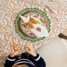 Classic round green scalloped placemats with white embroidery, perfect for Thanksgiving or holiday table settings, handcrafted from a premium cotton blend.