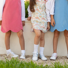 Henry Duvall Janey Jumper girls’ dress in Fall Floral with scalloped hem and fabric-covered shoulder buttons, designed for layering with blouses and turtlenecks for fall.