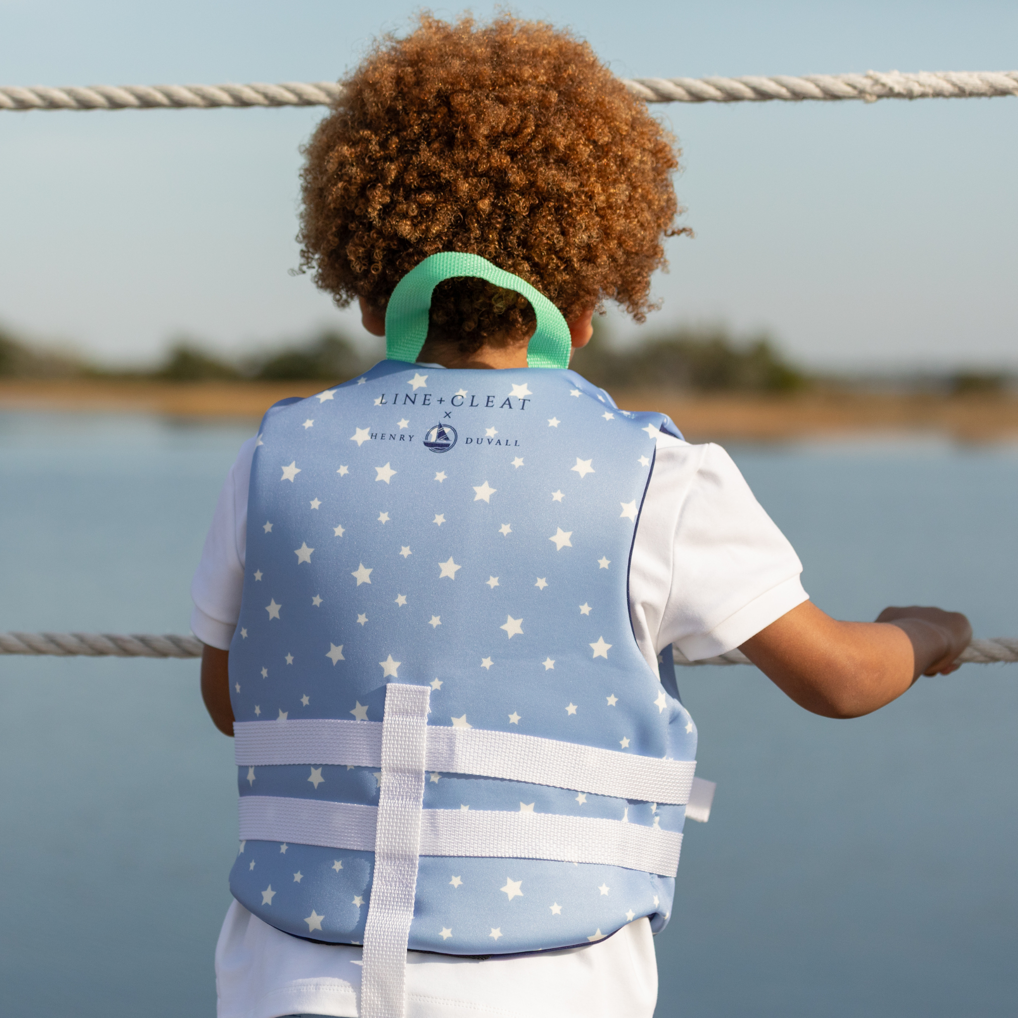 Stylish Henry Duvall x Line + Cleat kids life jacket in blue star print with zipper front and adjustable safety straps