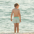 Classic boys’ swim trunks by Henry Duvall in a tailored above-the-knee fit with UPF 50+ protection, featuring an elastic waistband and drawstring for a comfortable summer look.
