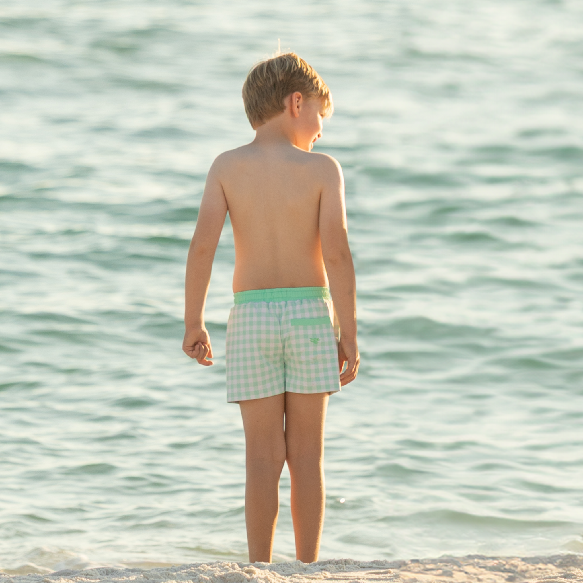 Classic boys’ swim trunks by Henry Duvall in a tailored above-the-knee fit with UPF 50+ protection, featuring an elastic waistband and drawstring for a comfortable summer look.