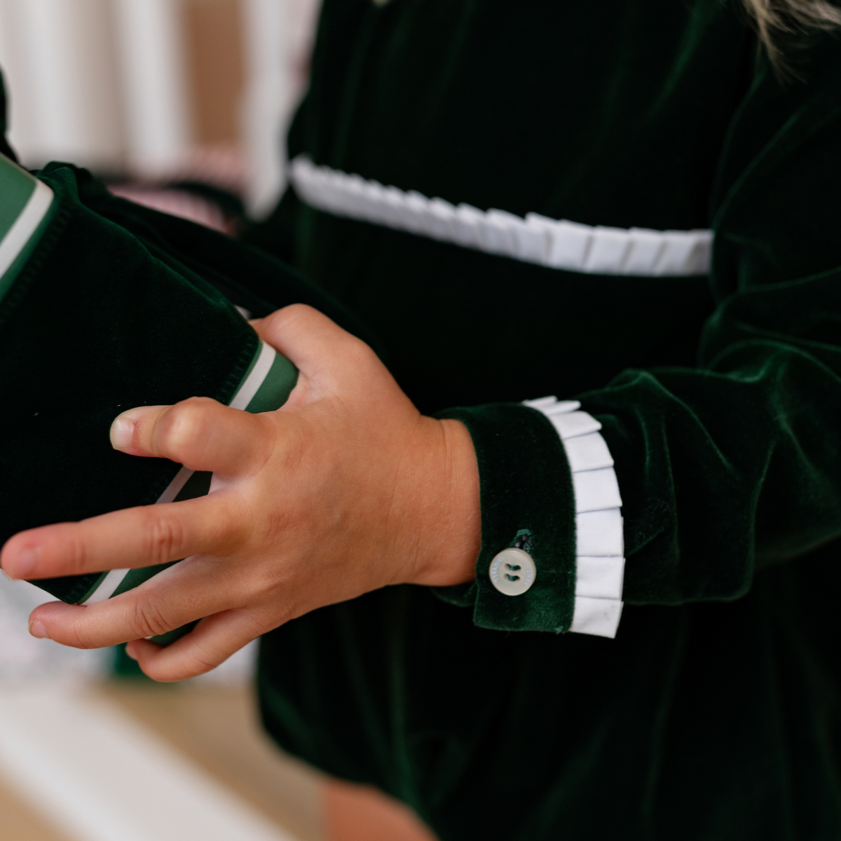 Baby girls’ Long Sleeve Grace Bubble in Grafton Green Velvet with a white pleated collar, waist and cuff trim.