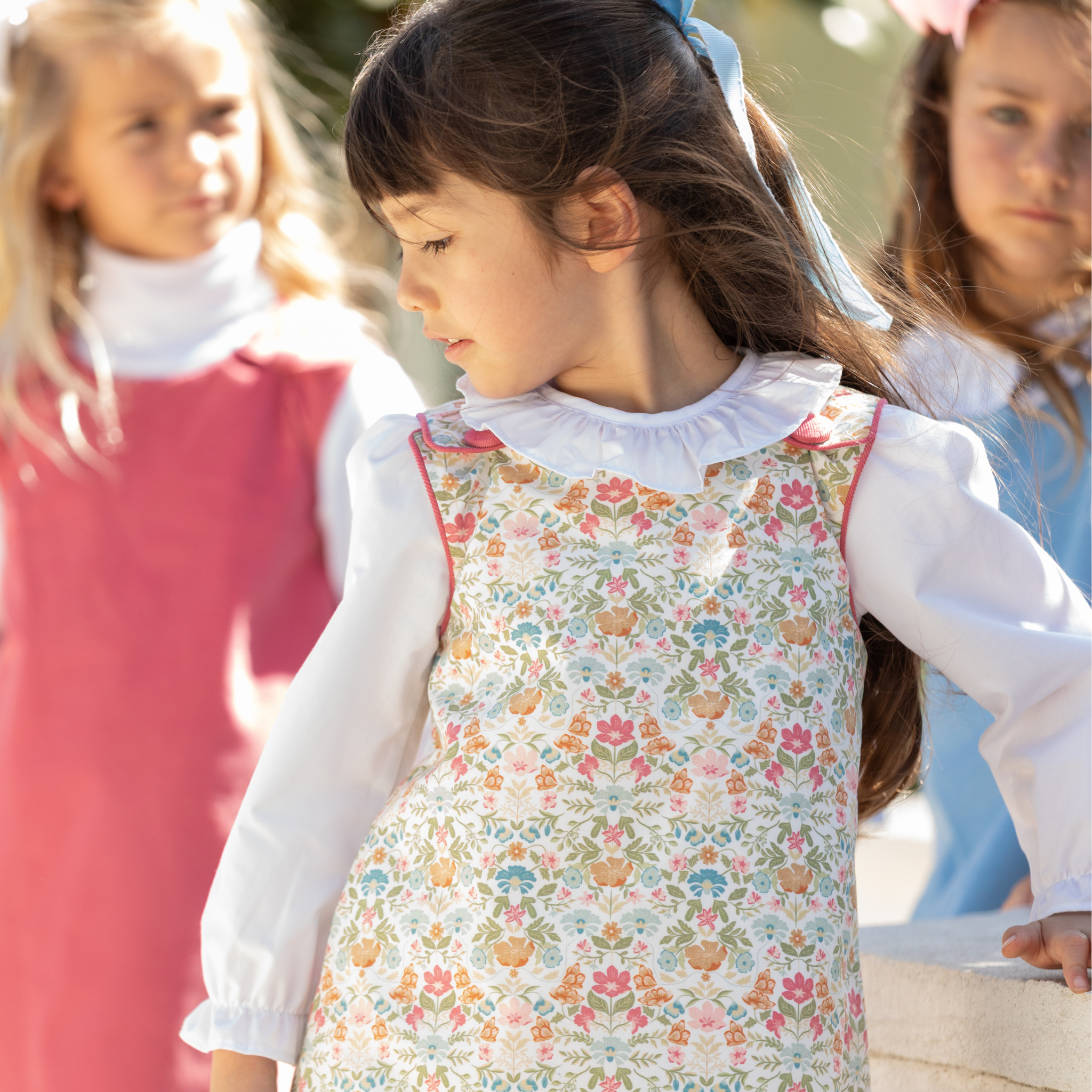 Henry Duvall Janie Jumper girls’ dress in Fall Floral with scalloped hem and fabric-covered shoulder buttons, designed for layering with blouses and turtlenecks for fall.