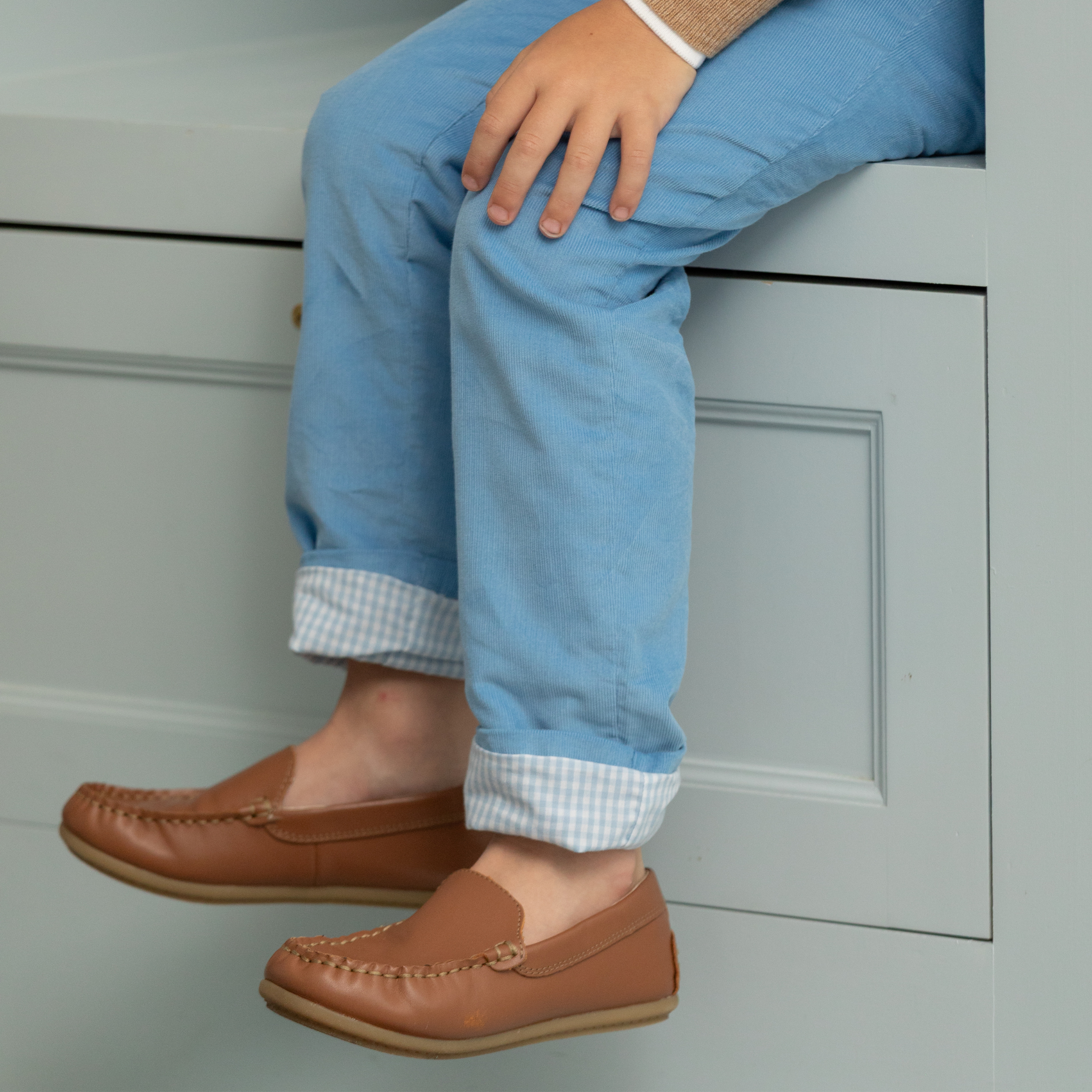 Henry Duvall Bradford Trousers in Brookhaven Blue light blue corduroy for boys, fully lined in Bay Tree Blue Check with contrast checked cuffs that can be rolled up or worn down.