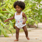 Henry Duvall unisex baby sunsuit in white with red and blue star appliqué and criss cross straps, classic patriotic outfit for Memorial Day, 4th of July, and summer occasions