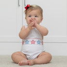 Henry Duvall unisex baby sunsuit in white with red and blue star appliqué and criss cross straps, classic patriotic outfit for Memorial Day, 4th of July, and summer occasions