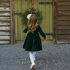 Baby girls’ Long Sleeve Grace Bubble in Grafton Green Velvet with a white pleated collar, waist and cuff trim.