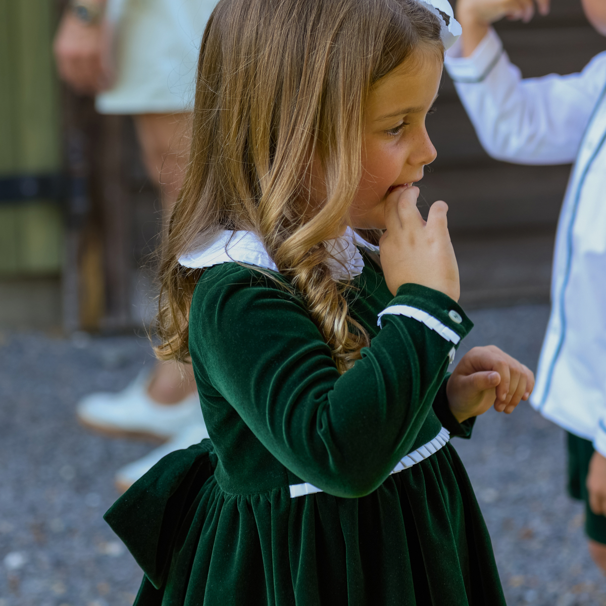 Baby girls’ Long Sleeve Grace Bubble in Grafton Green Velvet with a white pleated collar, waist and cuff trim.