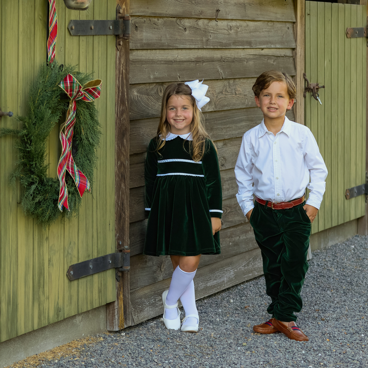Baby girls’ Long Sleeve Grace Bubble in Grafton Green Velvet with a white pleated collar, waist and cuff trim.