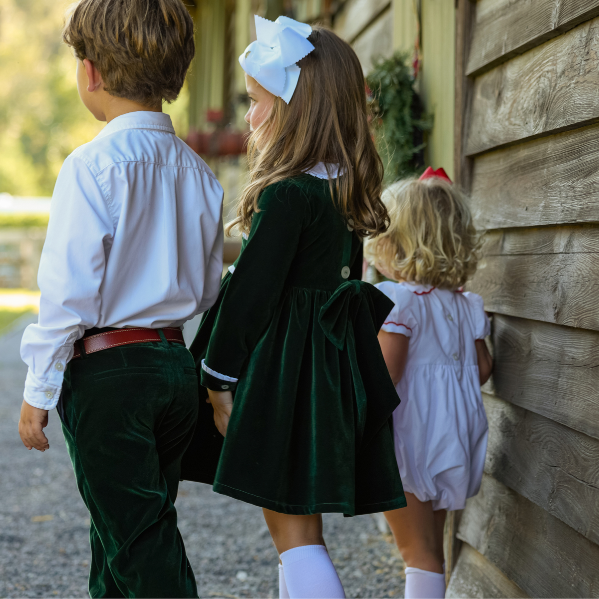 Baby girls’ Long Sleeve Grace Bubble in Grafton Green Velvet with a white pleated collar, waist and cuff trim.