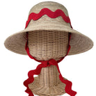 Woven sun hat with red ribbon on a mannequin head against a white background