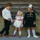 Baby girls’ Long Sleeve Grace Bubble in Grafton Green Velvet with a white pleated collar, waist and cuff trim.