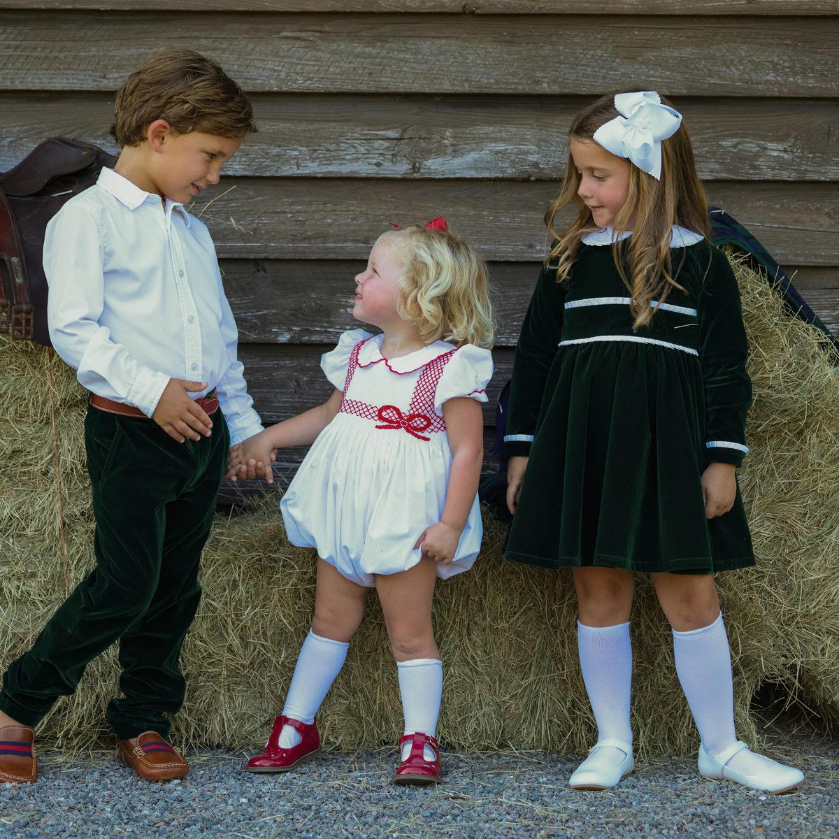 Baby girls’ Long Sleeve Grace Bubble in Grafton Green Velvet with a white pleated collar, waist and cuff trim.