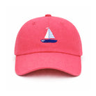 Pink cap with a sailboat emblem on a white background